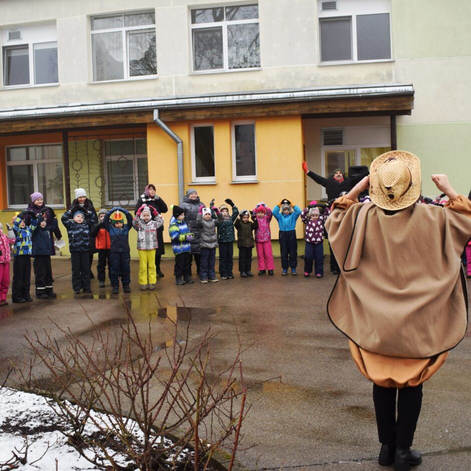 Visas grupas bērnudārza pagalmā dzied dziesmas.